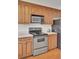 Well-lit kitchen with stainless steel appliances, wood cabinets, hardwood floor, and lots of counter space at 4512 Great Oak Dr, North Charleston, SC 29418