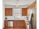 Well-lit kitchen features wood cabinets, stainless steel appliances, and a window for natural light at 4512 Great Oak Dr, North Charleston, SC 29418