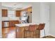 Well-lit kitchen with stainless steel appliances, wood cabinets, hardwood floor, and a breakfast bar at 4512 Great Oak Dr, North Charleston, SC 29418