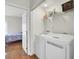 Laundry room with white washer and dryer adjacent to a bedroom with natural light at 4512 Great Oak Dr, North Charleston, SC 29418