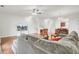 Bright living room featuring hardwood floors, access to kitchen, and a modern ceiling fan at 4512 Great Oak Dr, North Charleston, SC 29418
