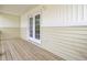 Covered porch with wooden decking and a view of white double doors at 4512 Great Oak Dr, North Charleston, SC 29418
