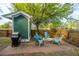Charming backyard with a stone fire pit, Adirondack chairs, and a gas grill at 5132 E Liberty Park Cir, North Charleston, SC 29405