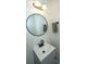 Clean and modern powder room features a stylish vanity, round mirror, and updated fixtures at 5132 E Liberty Park Cir, North Charleston, SC 29405
