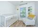Cozy Bedroom with a white crib, rocking chair, and bright window for a peaceful ambiance at 5132 E Liberty Park Cir, North Charleston, SC 29405