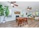 Bright dining room featuring wood table, ceiling fans, and a cozy fireplace at 5132 E Liberty Park Cir, North Charleston, SC 29405