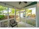 Relaxing screened porch featuring seating and view of the backyard with greenery and parking area at 5132 E Liberty Park Cir, North Charleston, SC 29405