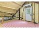 Attic area featuring spray foam insulation, mini-split AC unit, and exterior access door at 516 Central Ave, Summerville, SC 29483