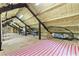 Large attic space with exposed beams, insulation, and ample room for utilities at 516 Central Ave, Summerville, SC 29483