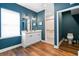 Bathroom features a double sink vanity, wood flooring, and a separate shower and toilet area at 516 Central Ave, Summerville, SC 29483