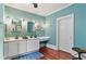 Bathroom with double vanity, blue walls and natural light from the window at 516 Central Ave, Summerville, SC 29483