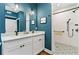 Well-lit bathroom with double sinks, granite countertop, and an accessible walk-in shower at 516 Central Ave, Summerville, SC 29483