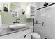 Modern bathroom featuring a stylish vanity, a large round mirror, and a sleek shower at 516 Central Ave, Summerville, SC 29483