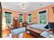 Comfortable bedroom showcasing three windows, wood floors, and a traditional style dresser at 516 Central Ave, Summerville, SC 29483