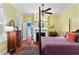 Bedroom with hardwood floors, a four-poster bed, ceiling fan, fireplace, and ensuite bathroom at 516 Central Ave, Summerville, SC 29483