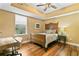 Cozy bedroom with a wooden bed frame, desk, and a large window providing natural light at 516 Central Ave, Summerville, SC 29483