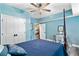 This is a blue bedroom with a four poster bed, ceiling fan and a small desk at 516 Central Ave, Summerville, SC 29483