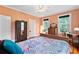 Bright bedroom with multiple windows, wood floors, and vintage furniture at 516 Central Ave, Summerville, SC 29483