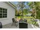 View of the deck with outdoor seating overlooking a manicured lawn and the main house at 516 Central Ave, Summerville, SC 29483