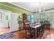 Large dining room with a chandelier, refinished wood floors and lots of light at 516 Central Ave, Summerville, SC 29483