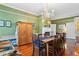 Spacious dining room with refinished wood floors, fireplace, and storage at 516 Central Ave, Summerville, SC 29483