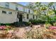 Charming home exterior with a brick patio, black wrought iron furniture and lush landscaping at 516 Central Ave, Summerville, SC 29483