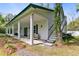 Charming exterior elevation with a long porch, white columns, and outdoor seating at 516 Central Ave, Summerville, SC 29483