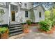 Charming home exterior featuring a welcoming front porch and landscaped yard at 516 Central Ave, Summerville, SC 29483