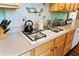 Kitchen counter showcasing stainless steel appliances and an undermount sink with designer faucet at 516 Central Ave, Summerville, SC 29483