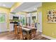 Well-lit kitchen with white cabinets, stainless steel appliances, and a rustic dining table at 516 Central Ave, Summerville, SC 29483