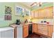 Bright kitchen with stainless steel refrigerator and modern appliances, plus light wood cabinetry and counterspace at 516 Central Ave, Summerville, SC 29483