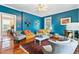 Bright, stylish living room with hardwood floors, blue walls, and eclectic decor at 516 Central Ave, Summerville, SC 29483