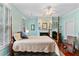 Serene main bedroom with four-poster bed, fireplace, and large windows at 516 Central Ave, Summerville, SC 29483