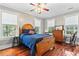Bedroom featuring hardwood floors, three windows, and a comfortable bed at 516 Central Ave, Summerville, SC 29483