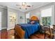 Bright bedroom boasts wood floors, ample windows, and access to the bathroom at 516 Central Ave, Summerville, SC 29483