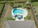 Aerial shot showcases the backyard oasis, including a pool, patio, and mature palm trees at 5509 Alpine Dr, Summerville, SC 29483