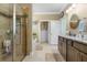 Spacious bathroom featuring a glass-enclosed shower, bathtub, and double sink vanity at 5509 Alpine Dr, Summerville, SC 29483