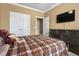 Comfortable bedroom featuring a plaid blanket, dresser and mounted TV at 5509 Alpine Dr, Summerville, SC 29483
