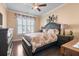 Cozy bedroom with a large window, dark wood floors, and floral bedding at 5509 Alpine Dr, Summerville, SC 29483