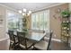 Light-filled dining room with modern chandelier, large windows, and hardwood floors at 5509 Alpine Dr, Summerville, SC 29483