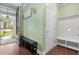Bright foyer with hardwood floors, storage bench, and a view of the landscaped front yard at 5509 Alpine Dr, Summerville, SC 29483