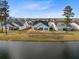 The backyard of this home has a view of the lake and a patio at 552 Marsh Cv Cir, Summerville, SC 29486