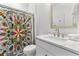 Stylish bathroom with a modern vanity, marble countertop, and vibrant shower curtain at 552 Marsh Cv Cir, Summerville, SC 29486