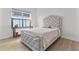 Comfortable bedroom with cozy bedding, a tufted headboard, and bright natural light at 552 Marsh Cv Cir, Summerville, SC 29486