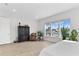 Bedroom featuring large windows offering serene views of the lake, with neutral decor at 552 Marsh Cv Cir, Summerville, SC 29486