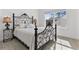 Comfortable bedroom with a decorative iron bed frame, natural light, and neutral decor at 552 Marsh Cv Cir, Summerville, SC 29486