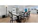 Dining room with large windows overlooking the lake, a modern table, and chairs at 552 Marsh Cv Cir, Summerville, SC 29486