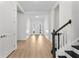 Bright entryway featuring white walls, laminate floors, crown molding, and stair case at 552 Marsh Cv Cir, Summerville, SC 29486
