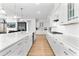 Bright kitchen with white cabinets, subway tile backsplash, and a view into the living area at 552 Marsh Cv Cir, Summerville, SC 29486