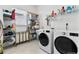Well-organized laundry room with modern washer and dryer, shelving, and ample storage space at 552 Marsh Cv Cir, Summerville, SC 29486